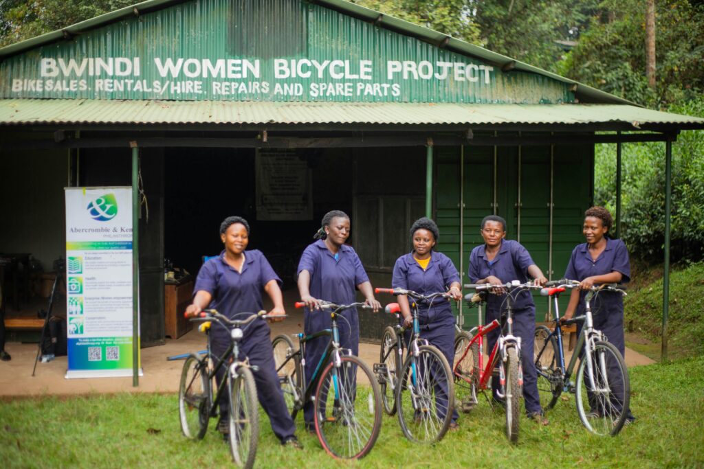 Uganda's Great Birding Arc Women from the Bwindi Bicycle Project pose with bicycles, promoting local empowerment.