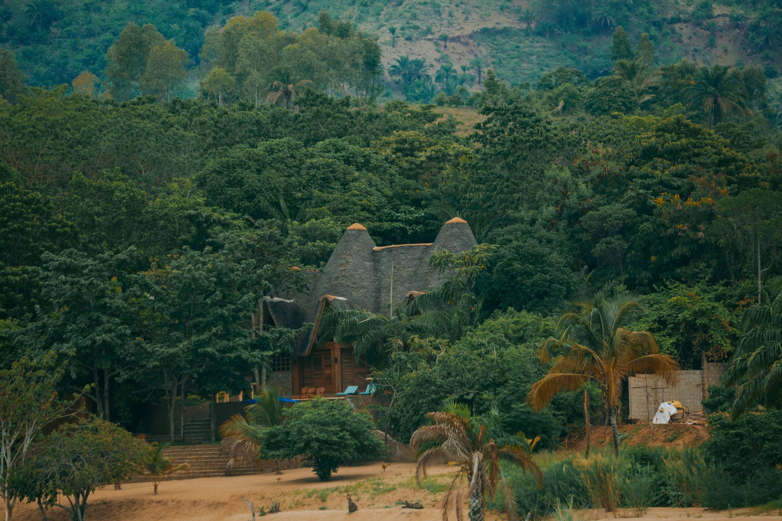 Secluded tropical lodge surrounded by dense forest, perfect for a nature retreat getaway.
